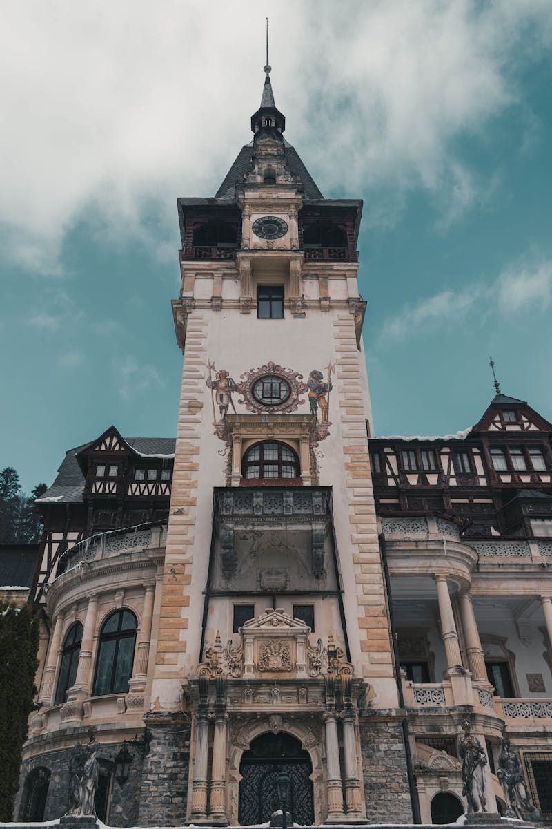 Stunning low angle view of Peles Castle showcasing intricate designs and baroque architecture.